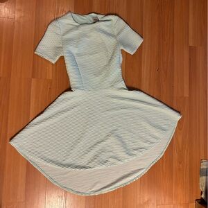 Mint textured hi-lo dress with cut out back and short sleeves.